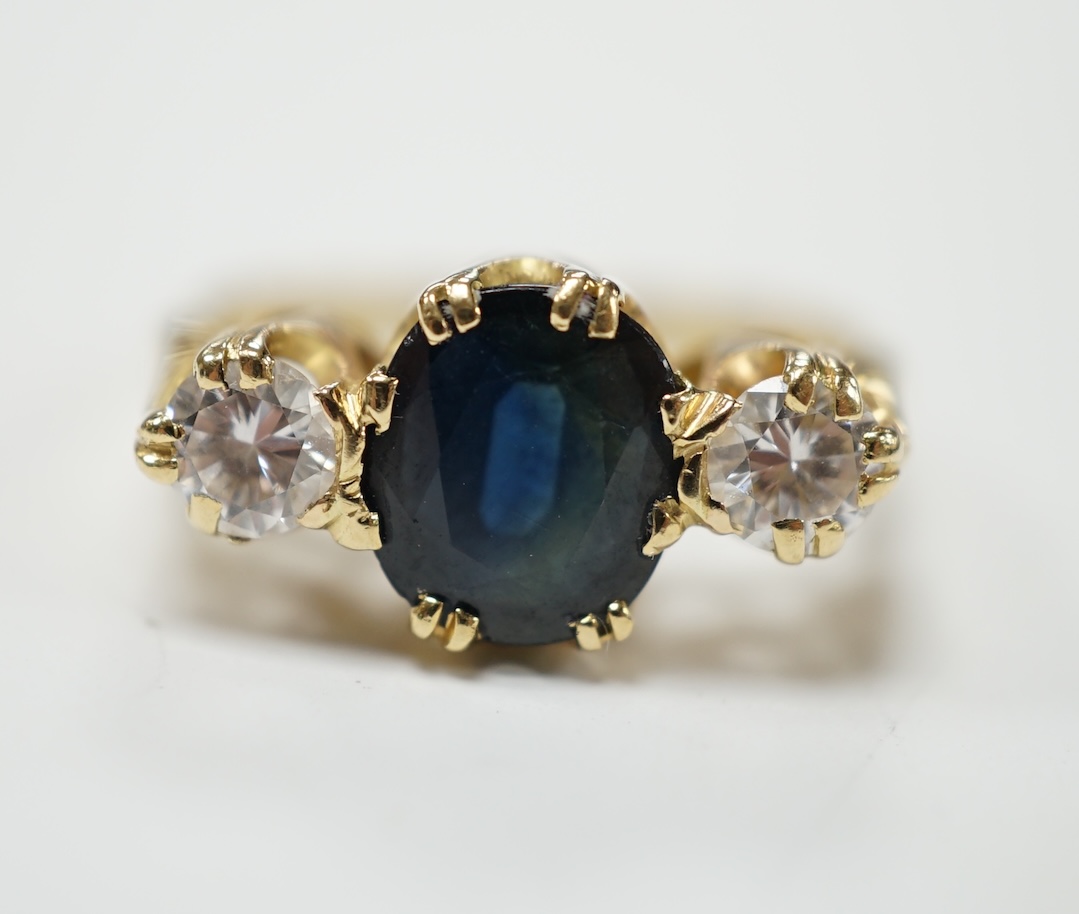 An 18ct, sapphire and diamond set three stone ring, size M/N, gross weight 4 grams. Fair condition.